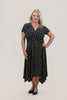 Image of Steven Guy Plus Size Surplice Neckline Short Sleeve Handkerchief Hem Dotted Dress - Black/Vanilla